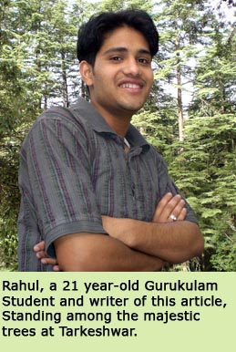 Rahul, a 21 year-old Gurukulam Student and writer of this article, Standing amonog the majestic trees at Tarkeshwar