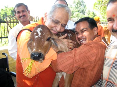 Swamiji huging cow